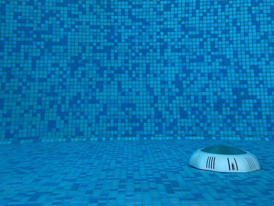 After: clean blue mosaic pool floor with a clear main drain